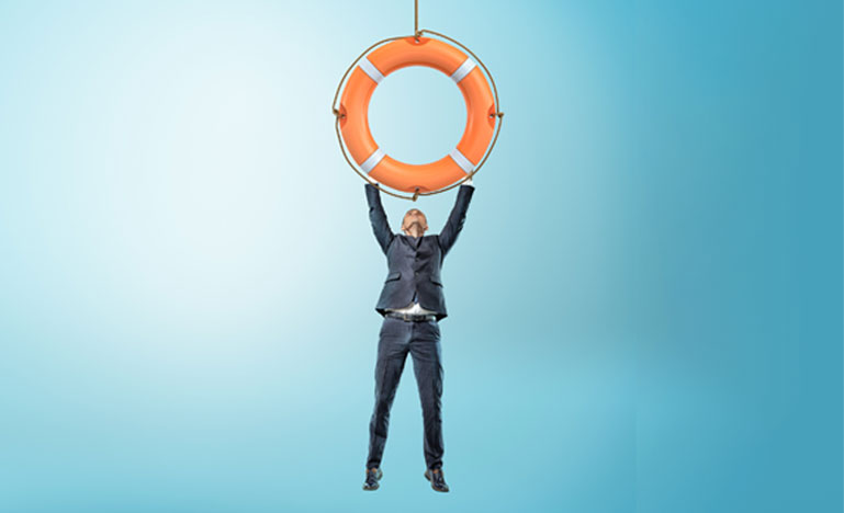 A tiny businessman holds on to a giant orange life buoy